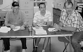 RILED UP &#8212; Pocahontas County Public Service District board members Chairman William Rexrode, Scott Millican and Mark Smith listen to comments about the Slatyfork sewage plant.